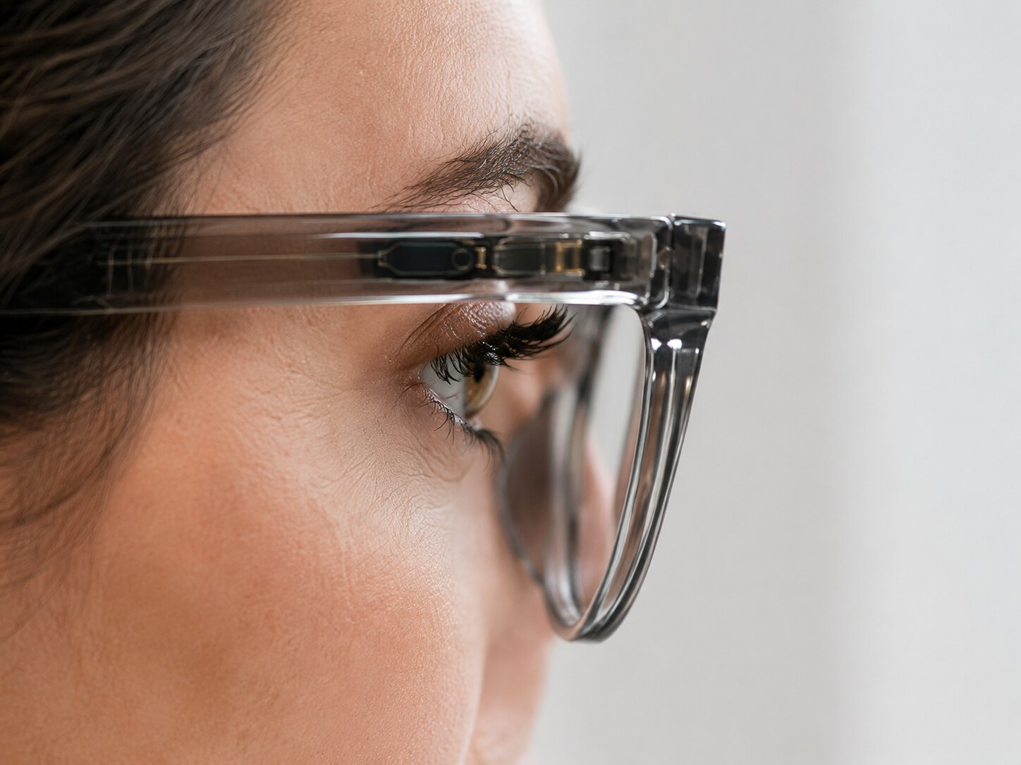 Profile view of a wearer, with the Motia sensor in the temple aimed at the eye